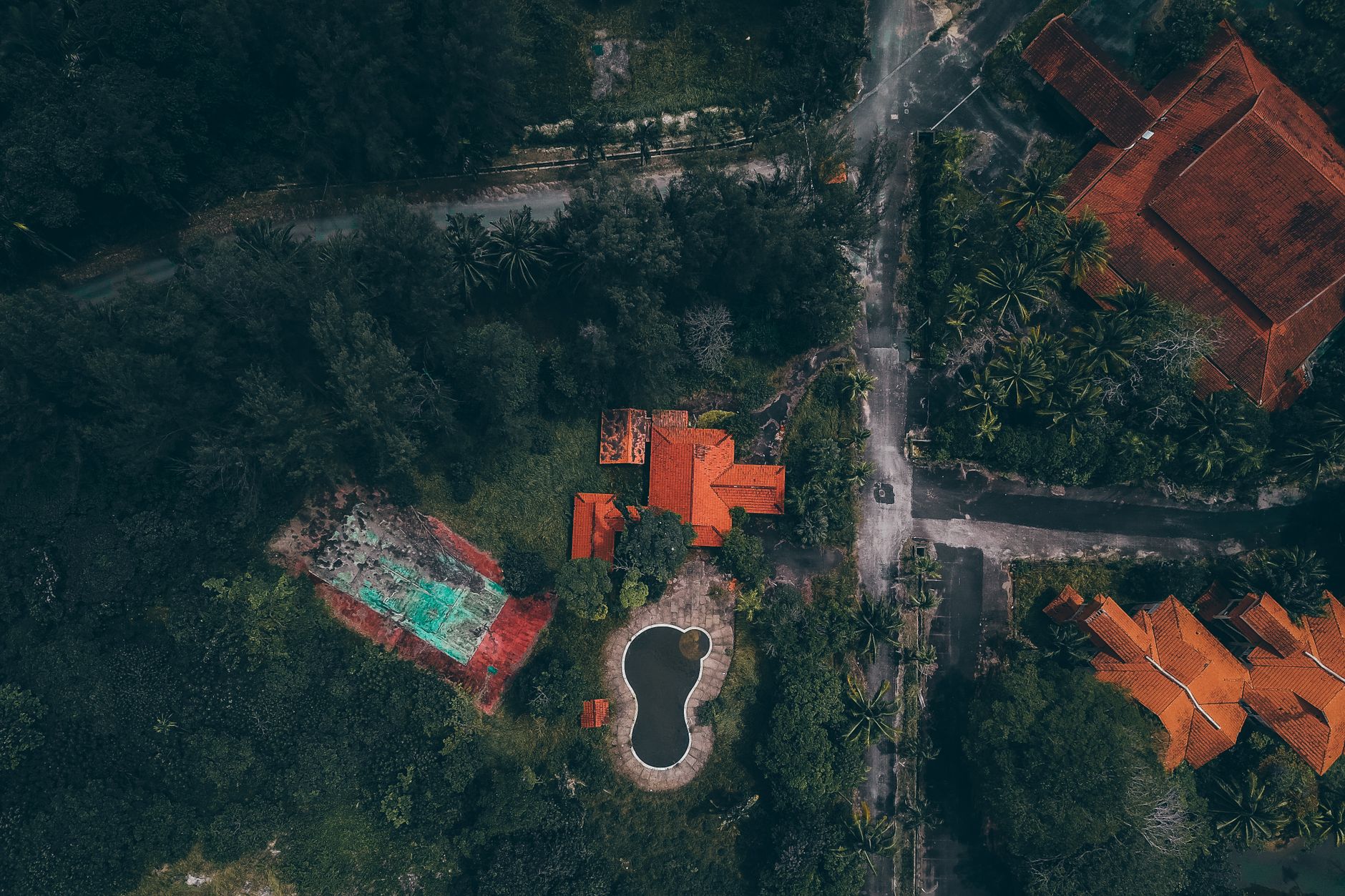 Aerial view of Singapore landed housing with red roofs and pools